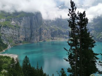 Scenic view of lake by trees against sky