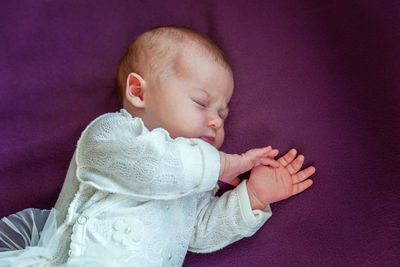 Close-up of cute baby boy against black background