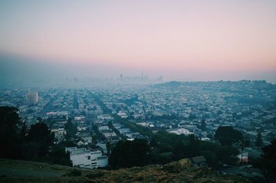 Aerial view of cityscape against sky during sunset