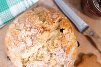 Freshly baked, homemade sweet cake with almonds and raisins on wooden board. easter loaf. 