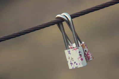 Close-up of padlocks attached to railing 