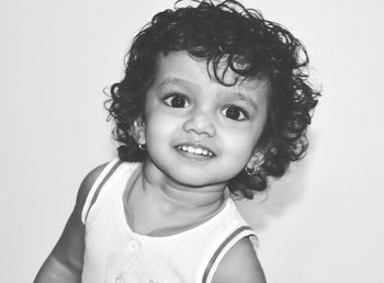 Portrait of cute smiling girl over white background