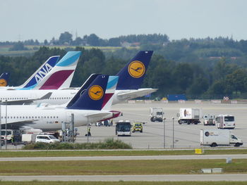 Airplane on airport runway against sky