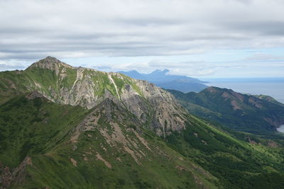 Scenic view of mountains against cloudy sky