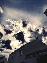 Low angle view of silhouette building against sky
