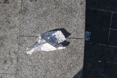 High angle view of arrow symbol on tiled floor