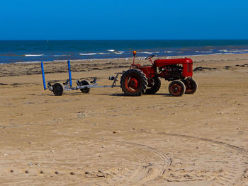 Bicycles on beach against clear sky