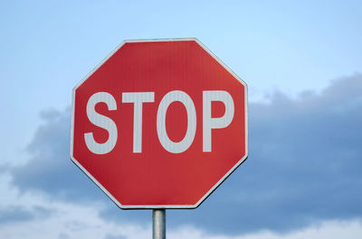 Low angle view of stop sign against sky