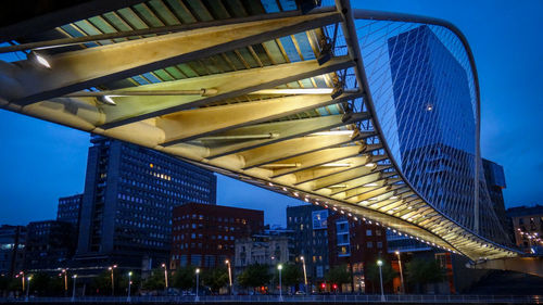 Low angle view of modern bridge against blue sky