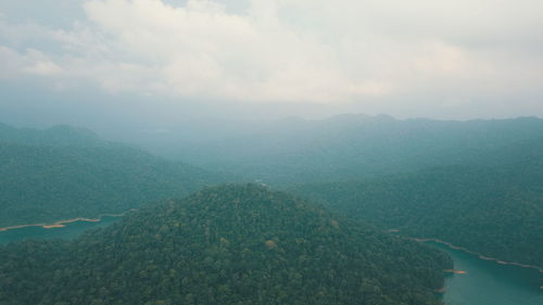 Scenic view of green landscape against sky