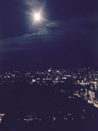 Illuminated city against sky at night