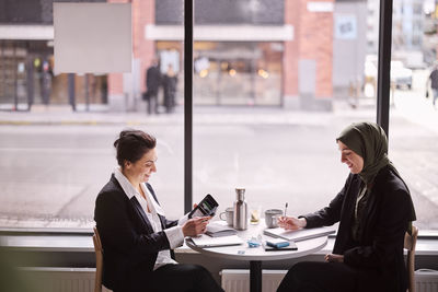 Smiling women sitting in cafe