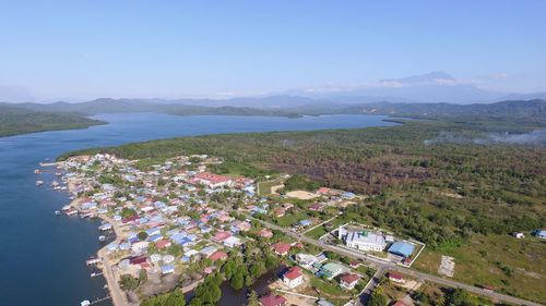 High angle view of townscape by sea against sky