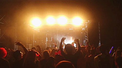 Rear view of people enjoying music concert