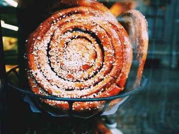 Close-up of cinnamon bun in bowl on table