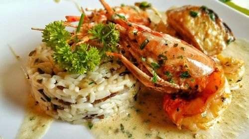 Close-up of rice and seafood served in plate