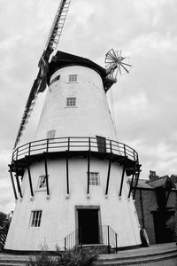 Low angle view of windmill against sky