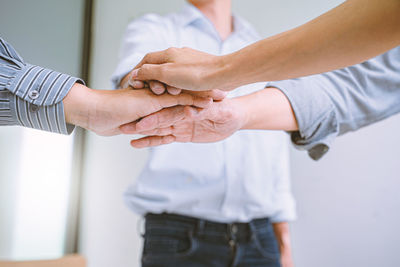 Midsection of couple holding hands