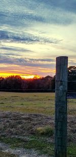 Scenic view of field against sky during sunset