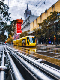 Tram on wet street in city