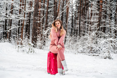 Portrait of woman in snow covered forest