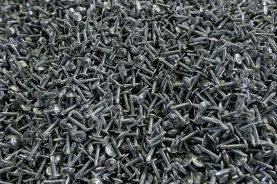 Full frame shot of screws in factory