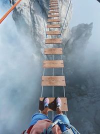 Low section of man standing on staircase