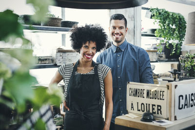 Portrait of multi-ethnic workers standing at checkout counter