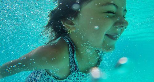 Close-up of wet woman in water