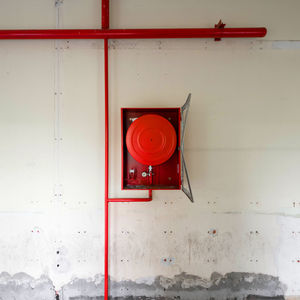 Red telephone booth on wall