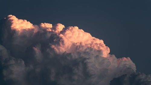 Low angle view of dramatic clouds in sky at sunset