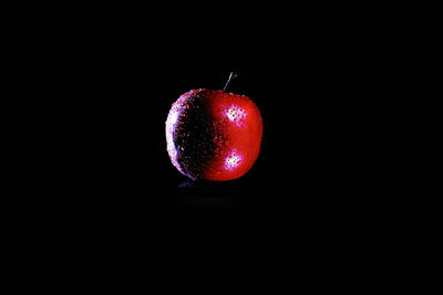 Close-up of apple against black background