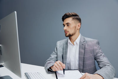 Young businesswoman working at desk in office