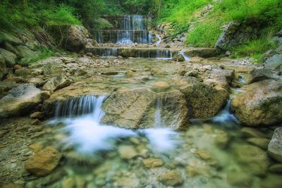 Scenic view of river flowing through rocks