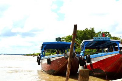 Boats moored at harbor