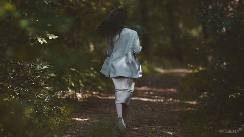 Rear view of woman walking on street