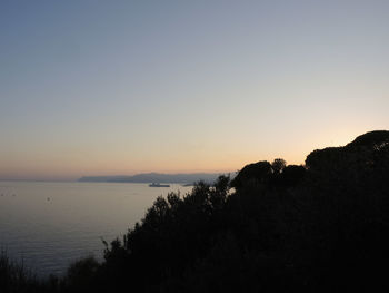 Scenic view of sea against clear sky during sunset