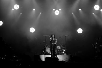 Man singing on stage during concert