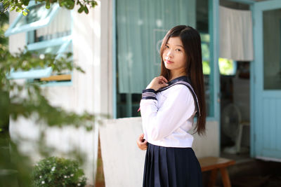 Portrait of young woman standing outdoors