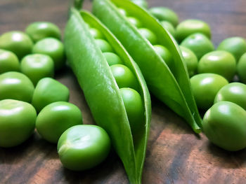 Close-up of green chili peppers on cutting board