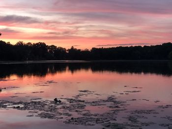 Scenic view of lake against orange sky