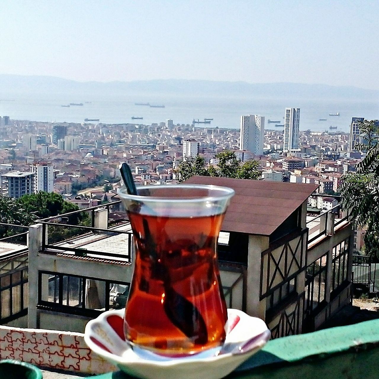 drink, food and drink, refreshment, freshness, table, building exterior, built structure, architecture, drinking glass, city, close-up, alcohol, drinking straw, glass, indoors, sky, focus on foreground, coffee - drink, glass - material, restaurant