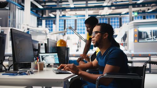 Rear view of man using mobile phone in cafe