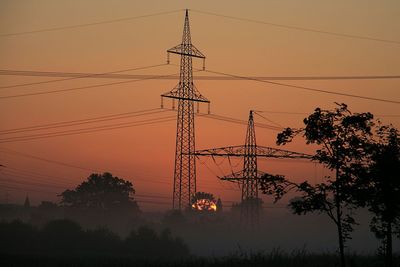 Low angle view of electricity pylon against sky