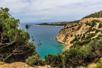 Scenic view of sea and mountains against sky