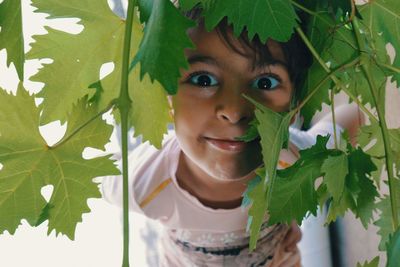 Portrait of a girl with green leaves