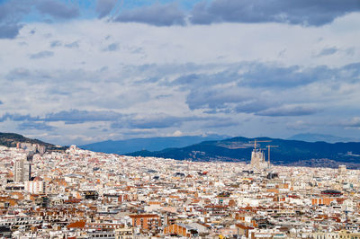 High angle view of townscape and sagrada familia against sky, barcelona 
