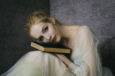 Charming ballerina went to the library to choose a new book showing your stretching and flexibility