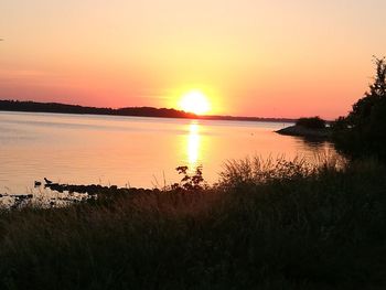 Scenic view of lake against sky during sunset