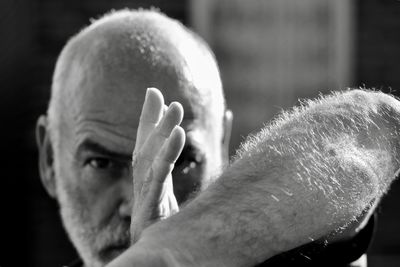 Close-up portrait of man practicing martial arts